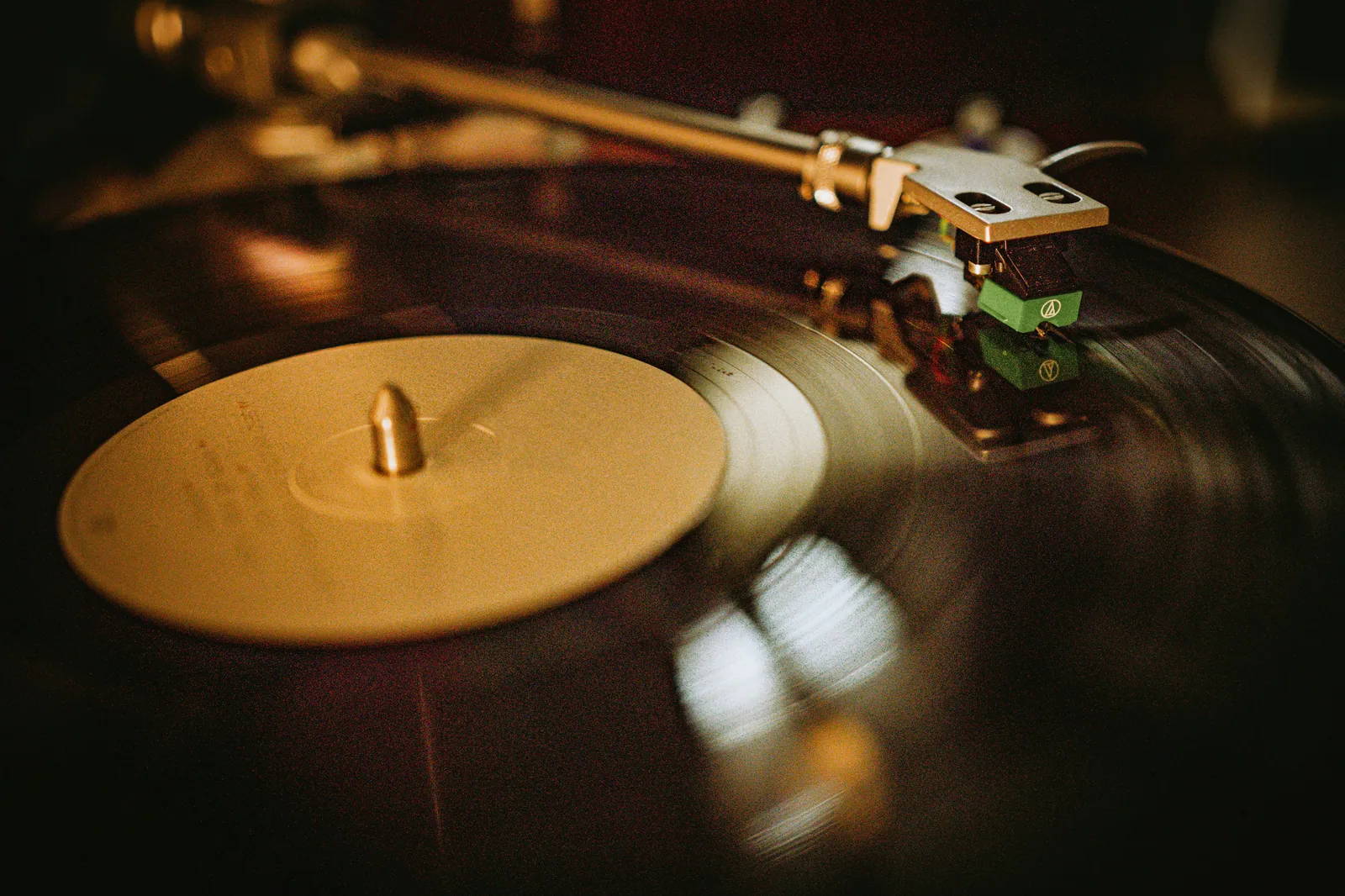 Gros plan chaleureux d'une platine vinyle en fonctionnement
